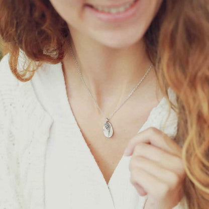 girl wearing a sterling silver December birth flower necklace