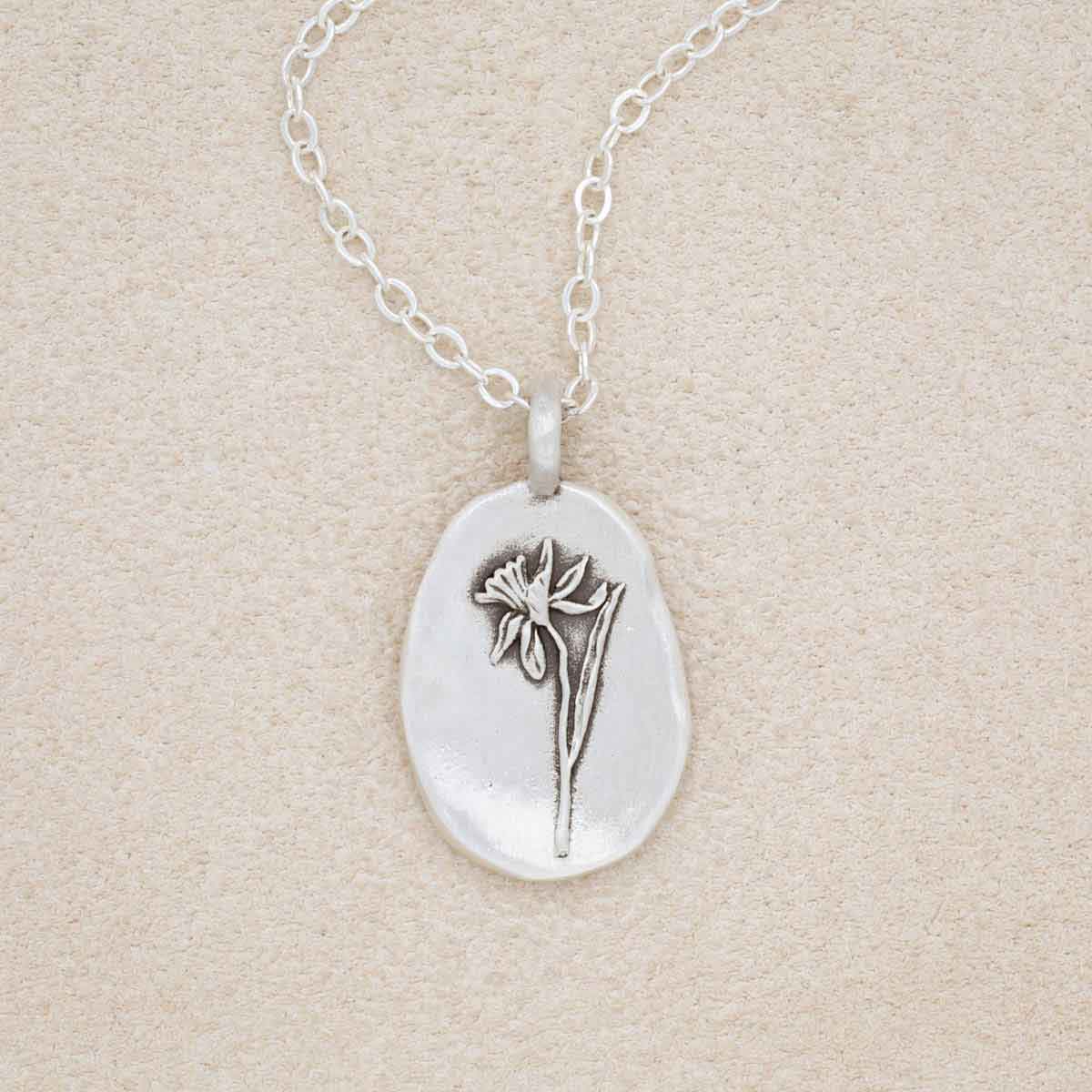 sterling silver December birth flower necklace, on beige background