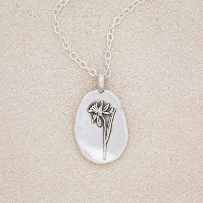 sterling silver December birth flower necklace, on beige background