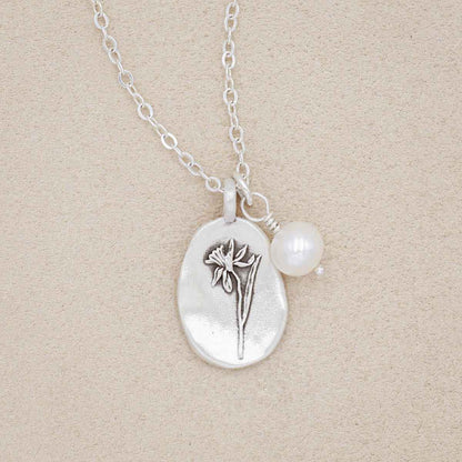 December birth flower necklace handcrafted in sterling silver with a special birth month charm strung with a vintage freshwater pearl