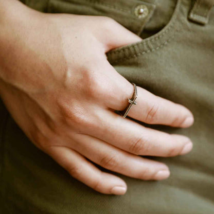 woman holding a blackened sterling silver Dimensions Cross Ring