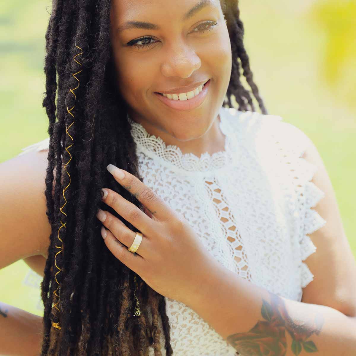 Girl wearing her Faith Hope and Love ring hand-molded in 10k yellow gold set with a 3mm birthstone or diamond and two 2mm stones on the sides 