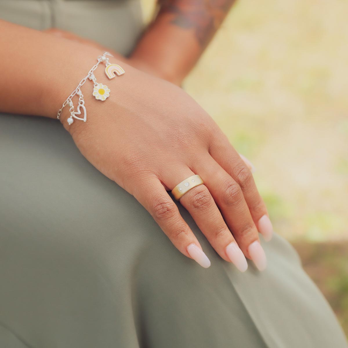 Girl wearing her Faith Hope and Love ring hand-molded in 10k yellow gold set with a 3mm birthstone or diamond and two 2mm stones on the sides 