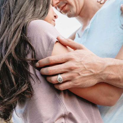 Man wearing Faith Hope and Love Cross Signet ring handcrafted in sterling silver with an antiqued finish with his girlfriend