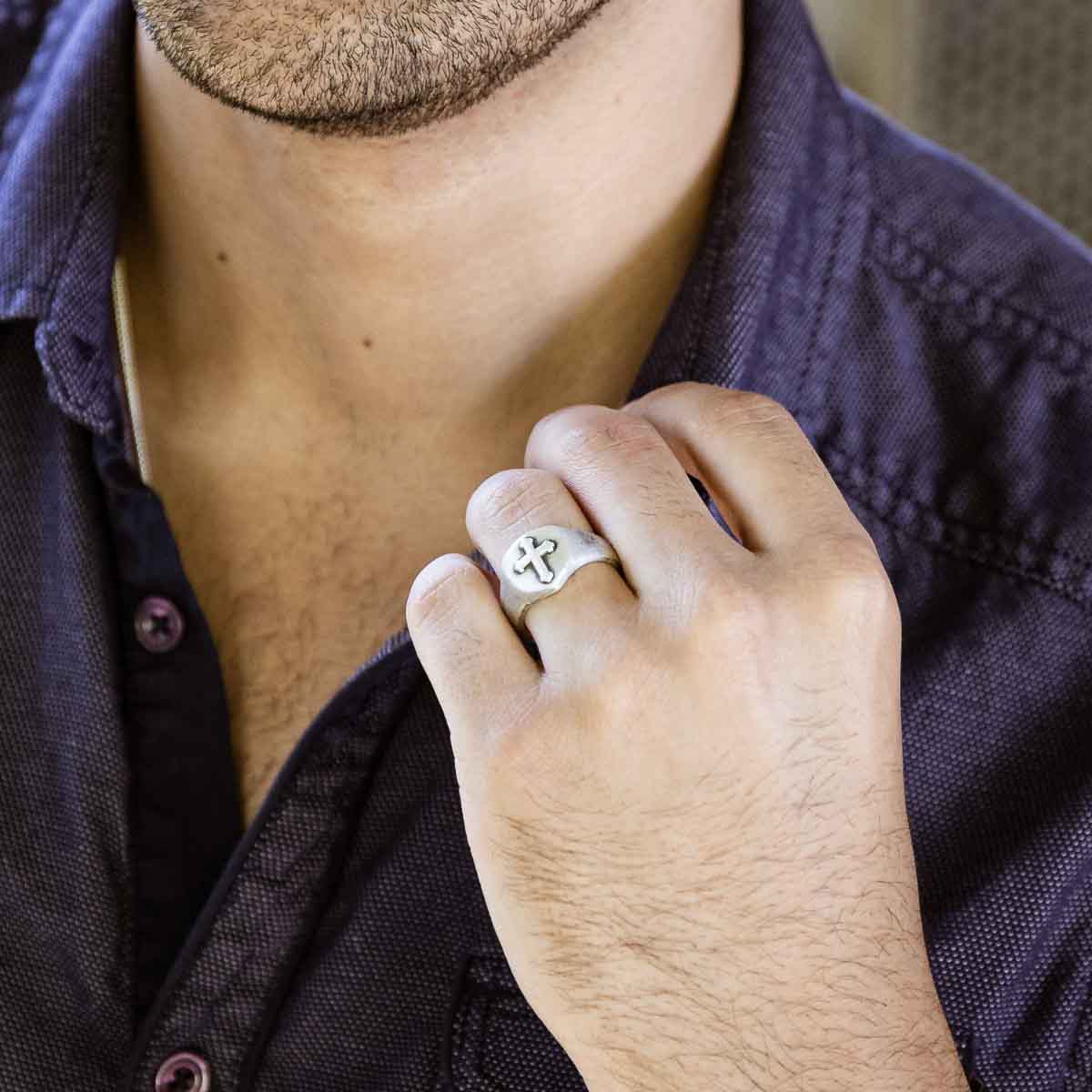 Man wearing Faith Hope and Love Cross Signet ring handcrafted in sterling silver with an antiqued finish