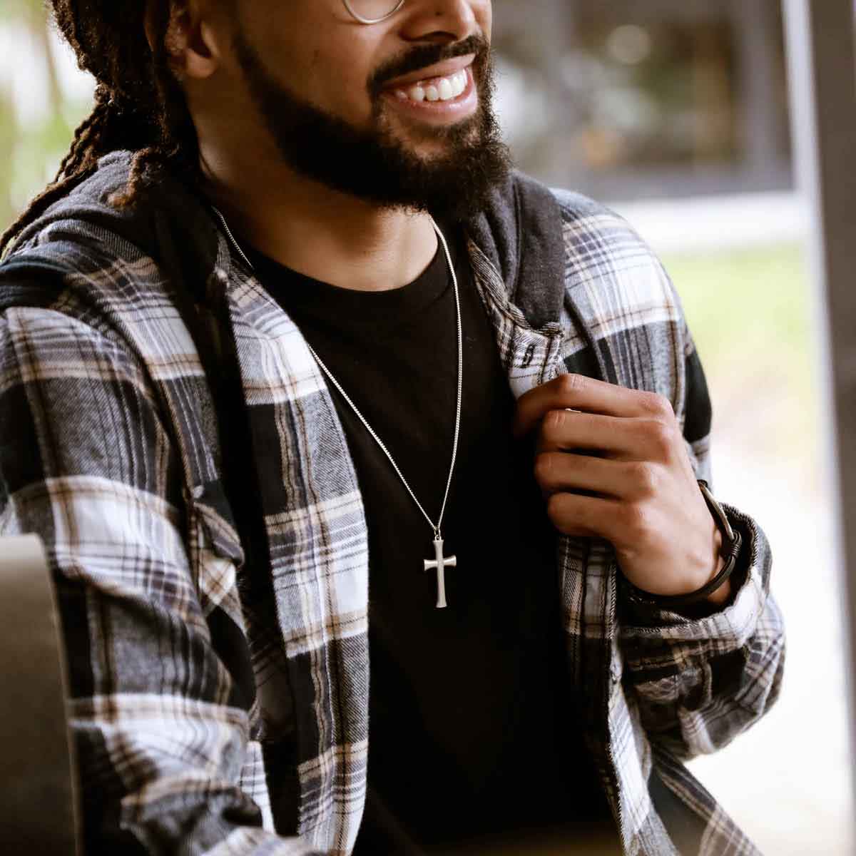 man wearing a sterling silver Faith Through Love Cross Necklace