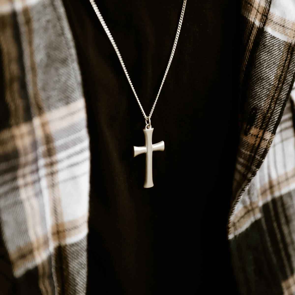 man wearing a sterling silver Faith Through Love Cross Necklace