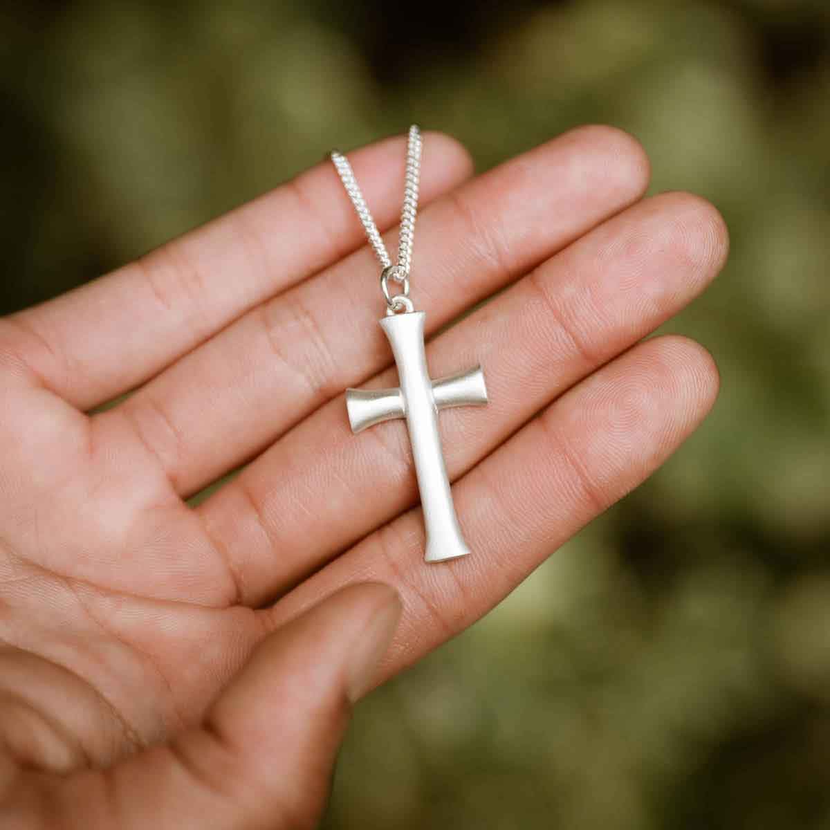 man wearing a sterling silver Faith Through Love Cross Necklace