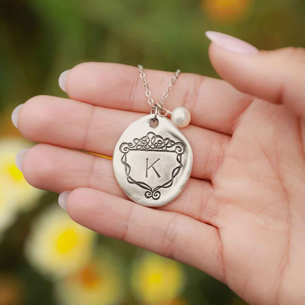 Girl wearing a Family Crest necklace handcrafted in pewter