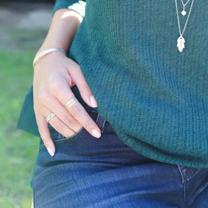 Girl wearing Featherweight stacking rings with 3 stackable ring handcrafted in sterling silver