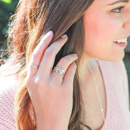 Girl wearing Featherweight stacking rings with 3 stackable ring handcrafted in sterling silver