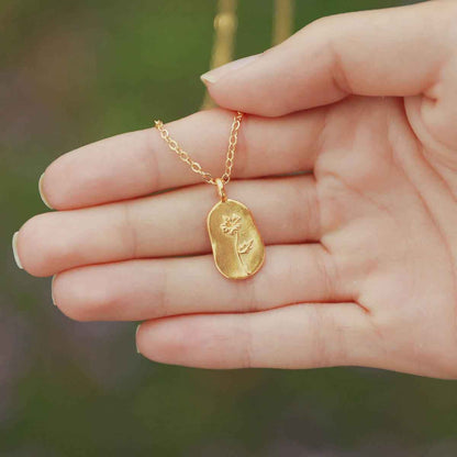 girl wearing a gold plated February birth flower necklace with an 18" gold filled link chain