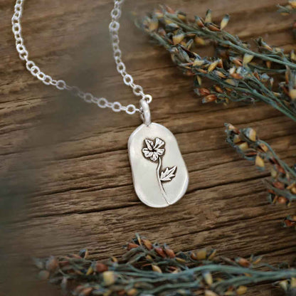 girl wearing a sterling silver February birth flower necklace