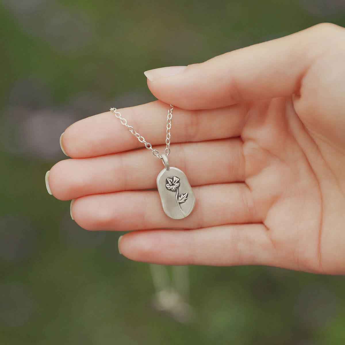 girl wearing a sterling silver February birth flower necklace