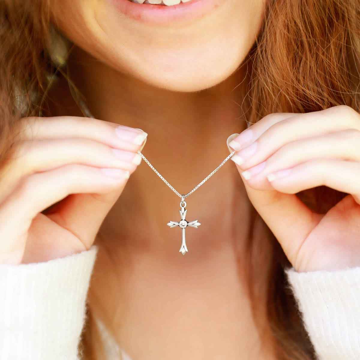 woman wearing a sterling silver Firstfruits Cross Necklace