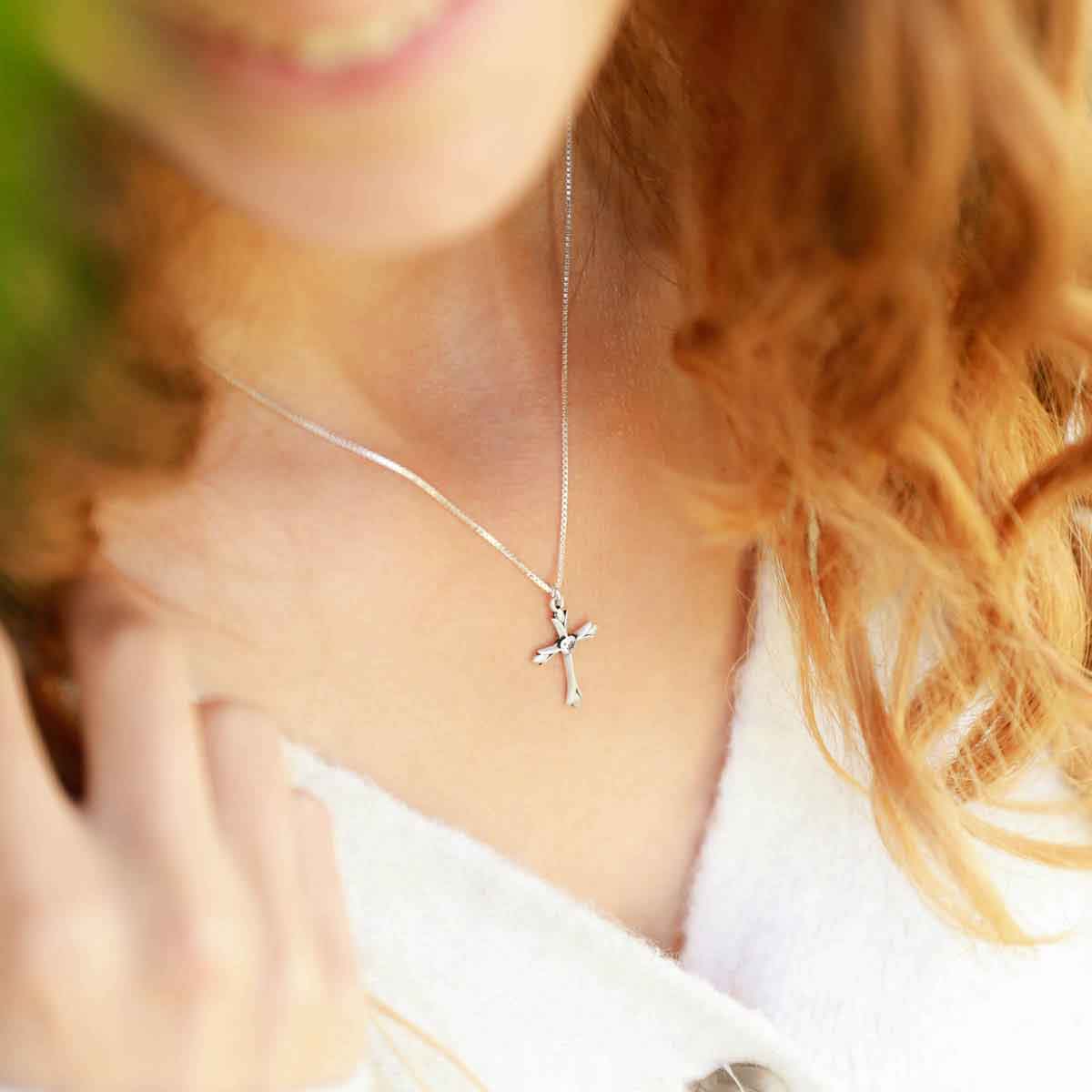 woman wearing a sterling silver Firstfruits Cross Necklace