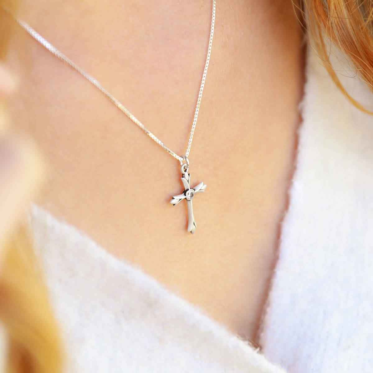 woman wearing a sterling silver Firstfruits Cross Necklace