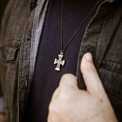 man wearing a sterling silver Flourish Cross Necklace