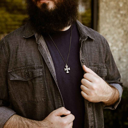 man wearing a sterling silver Flourish Cross Necklace