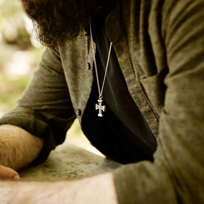 man wearing a sterling silver Flourish Cross Necklace