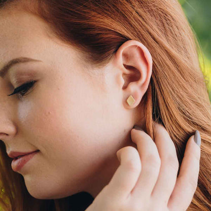 girl wearing Fly A Kite Stud Earrings handcrafted in 10k Gold