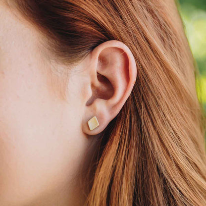 girl wearing Fly A Kite Stud Earrings handcrafted in 10k Gold