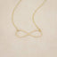 A gold filled Forever, For Always Infinity Necklace, on a beige background