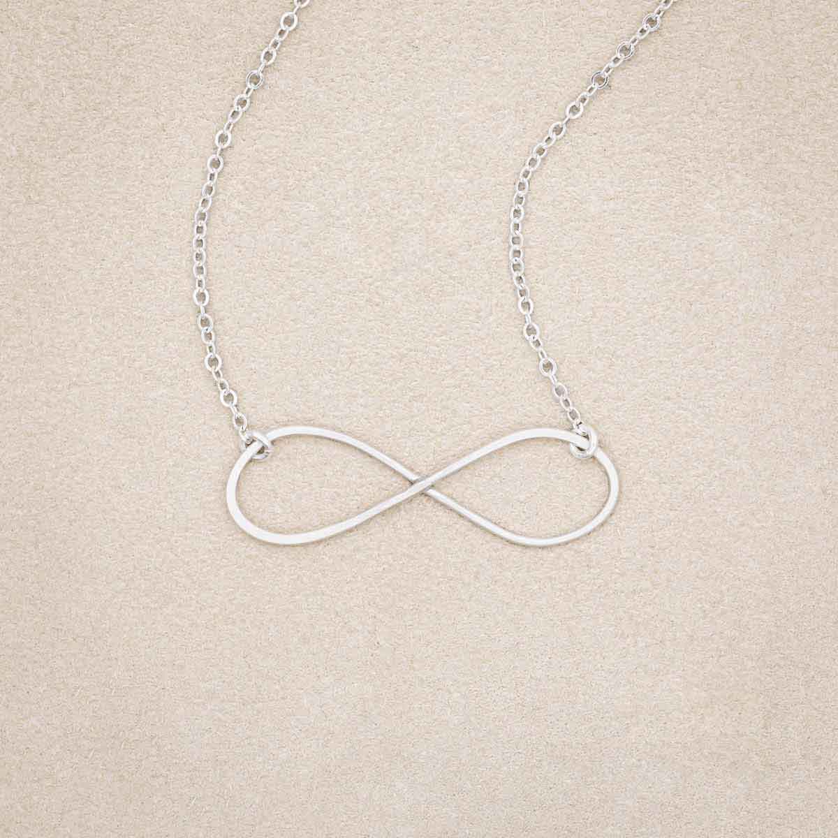 A sterling silver Forever, For Always Infinity Necklace, on beige background