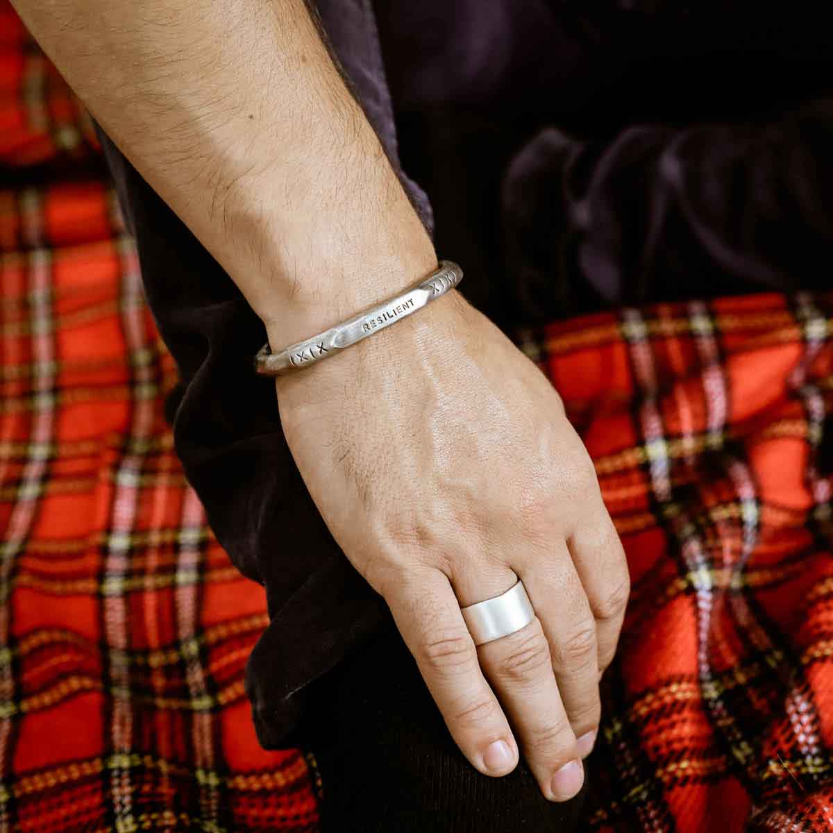 Man displaying Forge a path men's cuff bracelet hand-carved in fine pewter personalized with a name