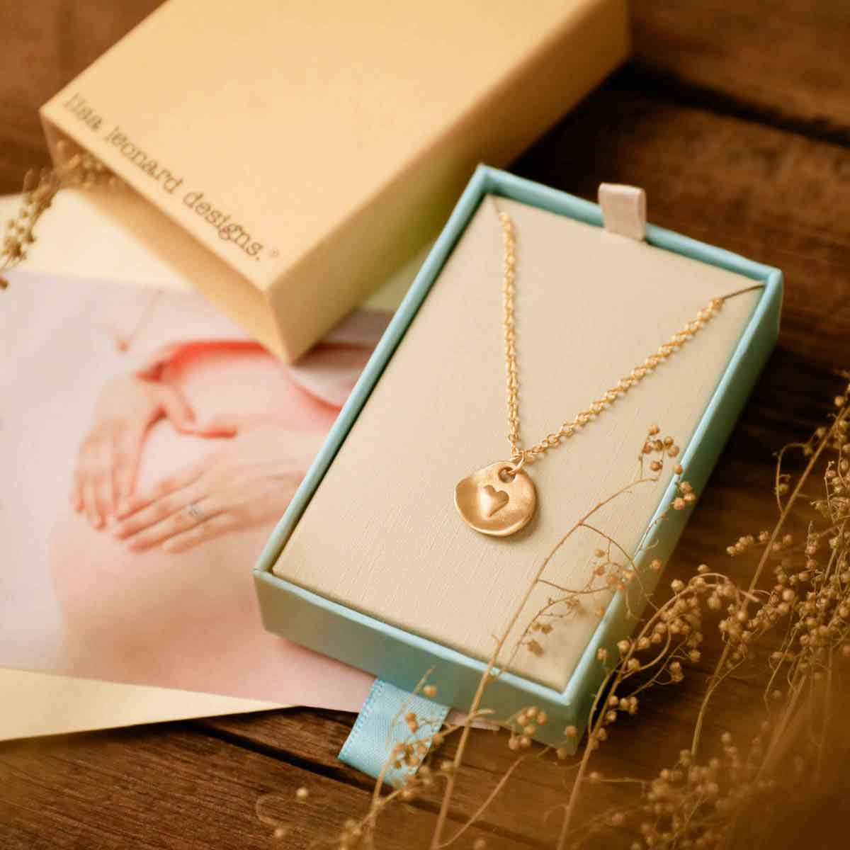 14k yellow gold full of love necklace strung on gold-filled link chain in a lisa leonard necklace gift box