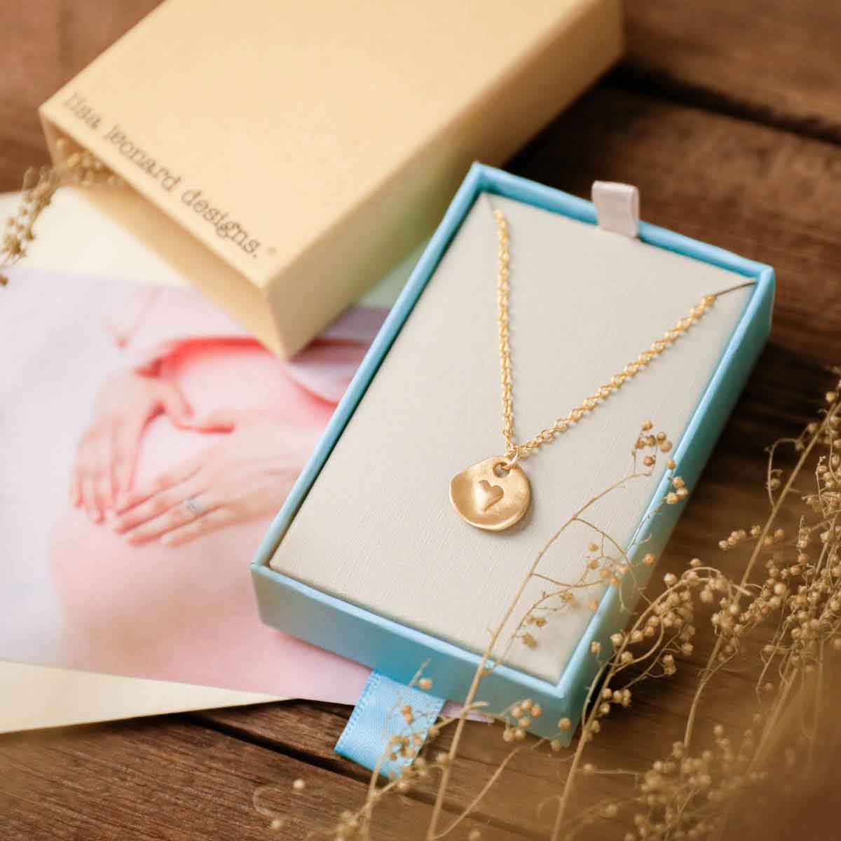 10k yellow gold full of love necklace strung on gold-filled link chain in a lisa leonard necklace gift box