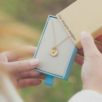 10k yellow gold full of love necklace strung on gold-filled link chain in a lisa leonard necklace gift box