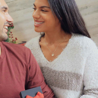 woman wearing a sterling silver full of love necklace giving gift to spouse