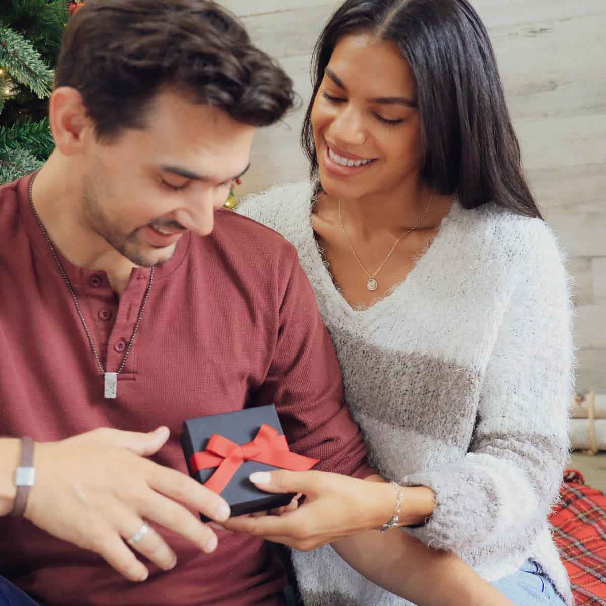 woman wearing a sterling silver full of love necklace giving gift to spouse