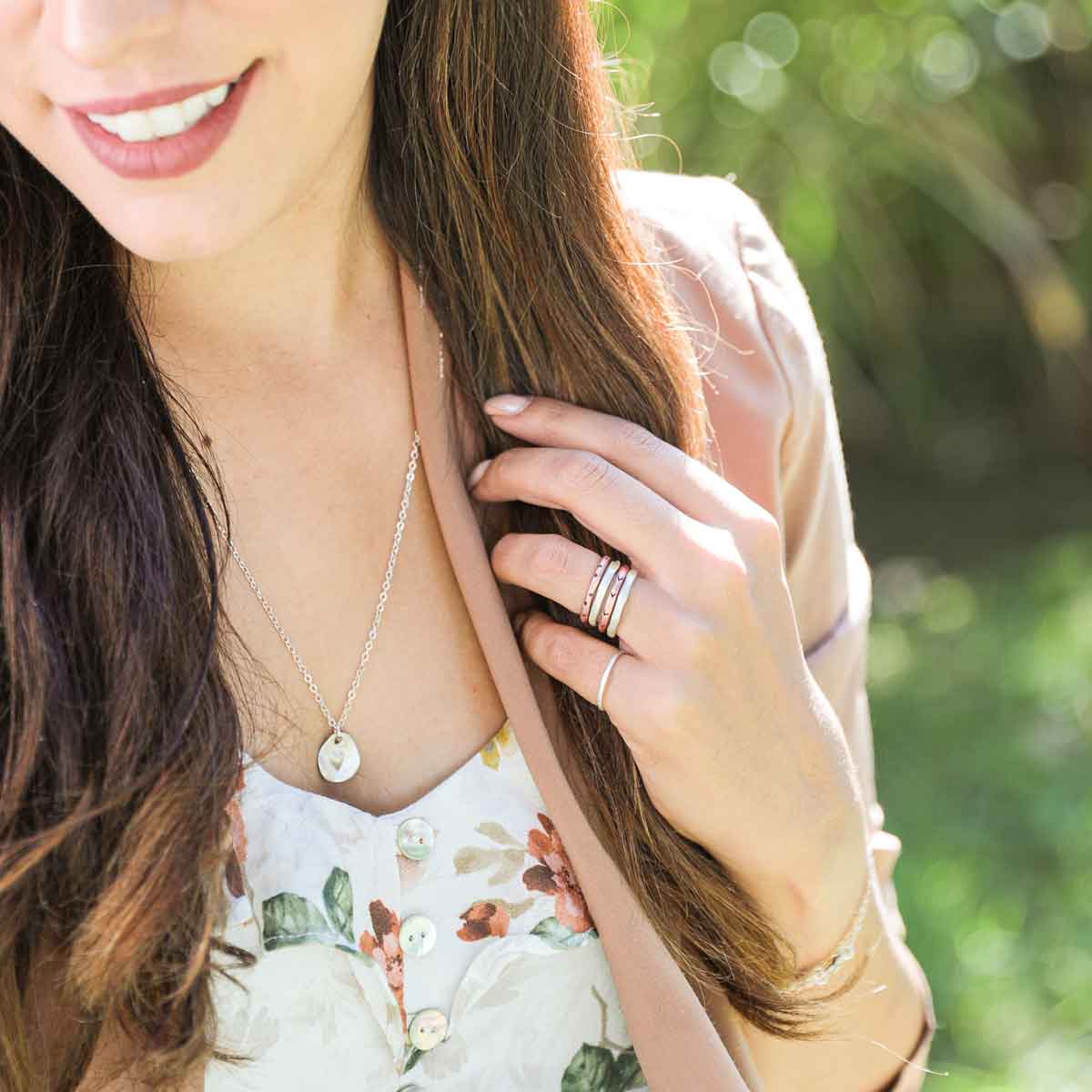 woman wearing her sterling silver full of love necklace