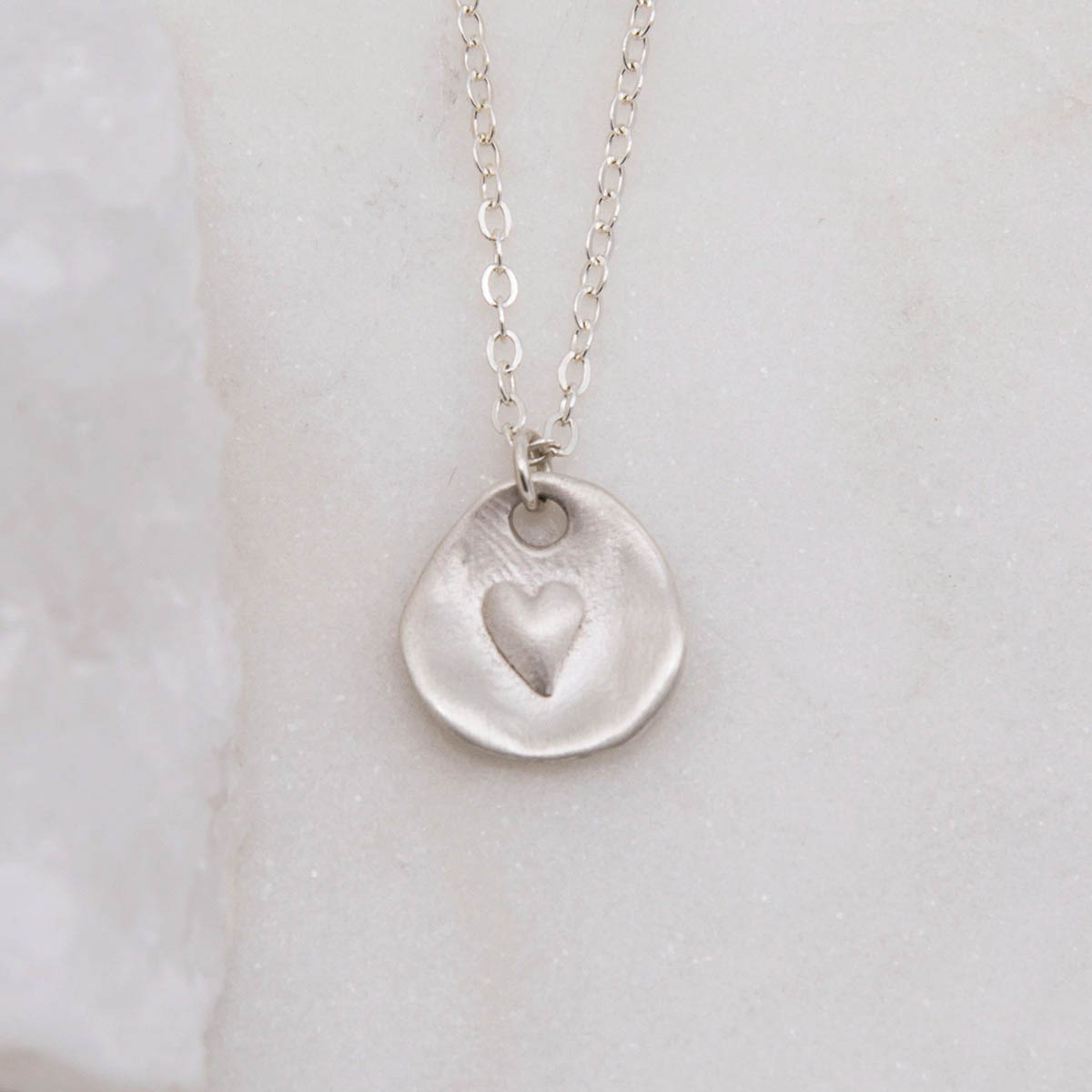 sterling silver heart charm strung on sterling silver link chain full of love necklace 