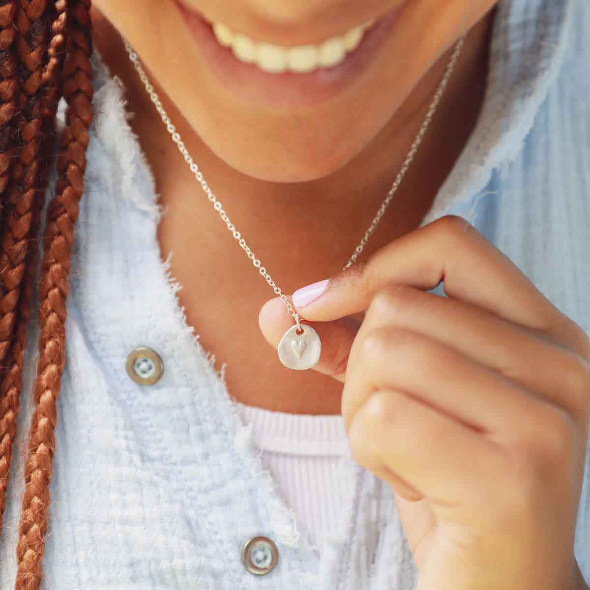 woman wearing a sterling silver full of love necklace 