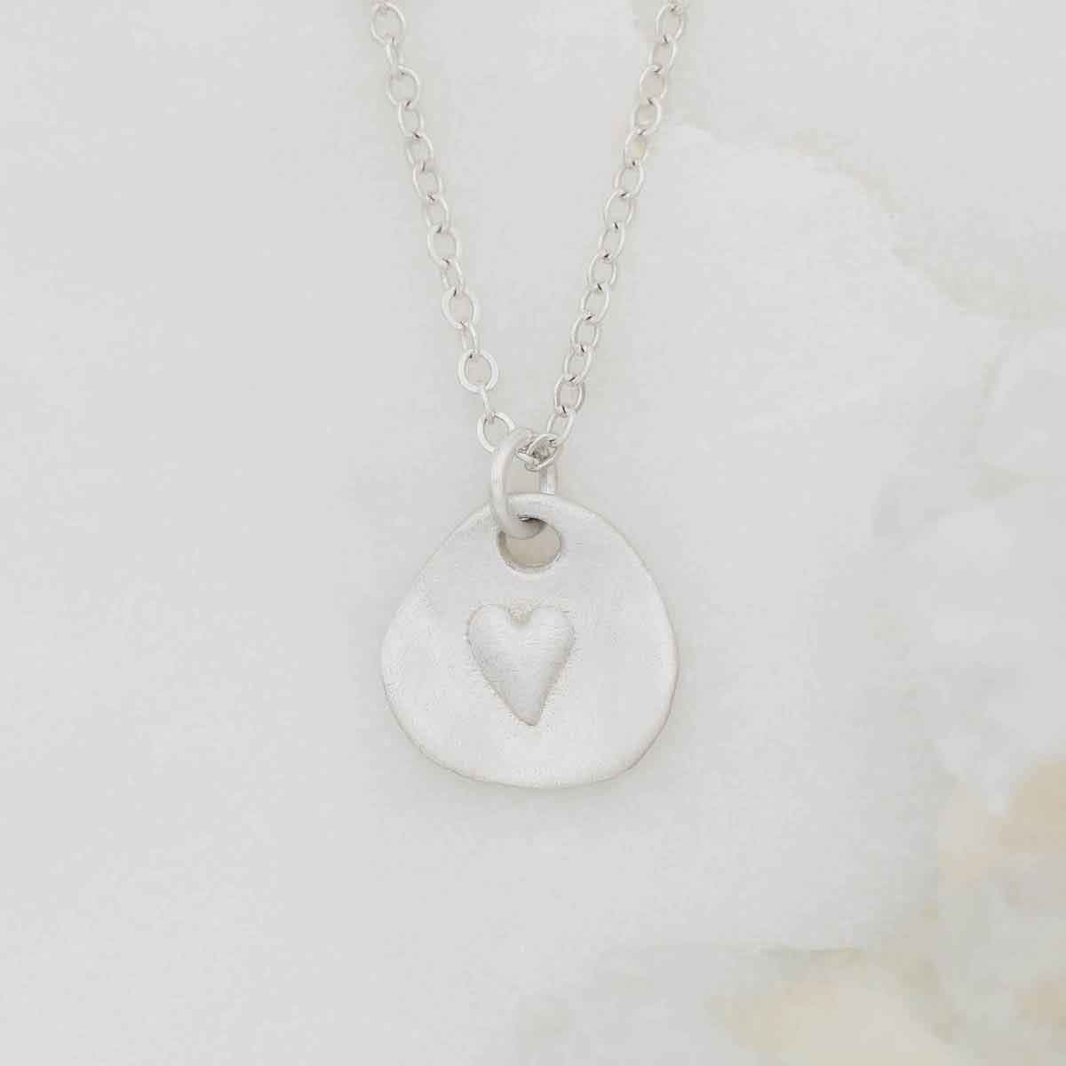 sterling silver heart charm strung on sterling silver link chain full of love necklace 