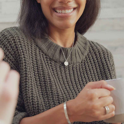 woman wearing her sterling silver full of love necklace