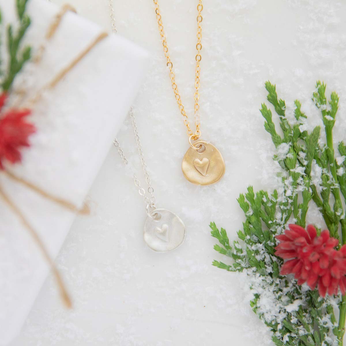 sterling silver and yellow gold full of love necklace on snow