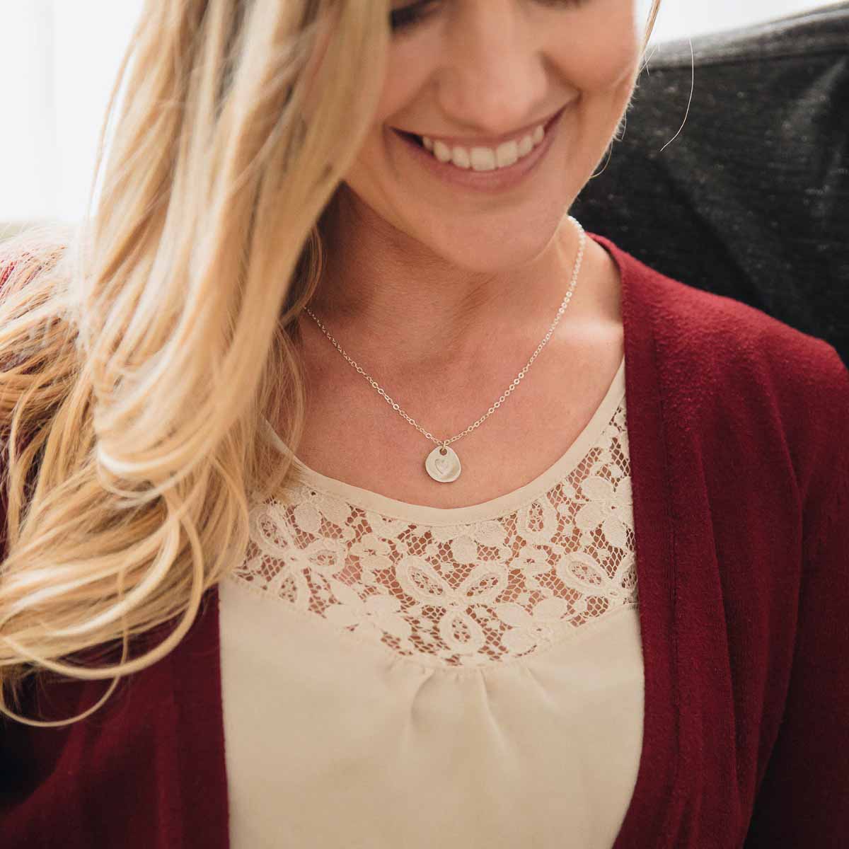 woman wearing her sterling silver full of love necklace