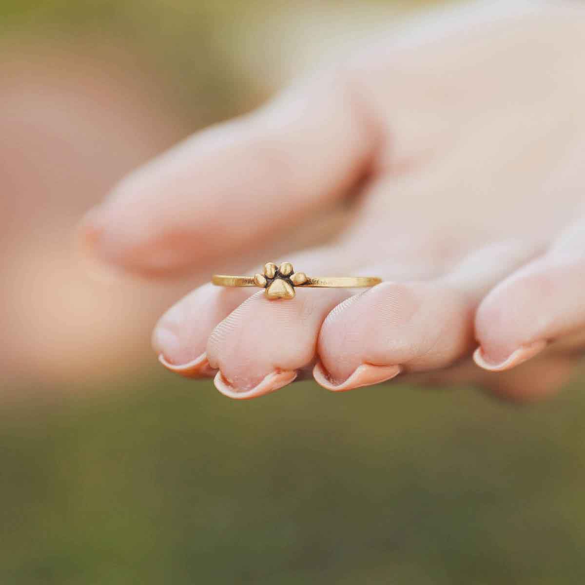 girl wearing a Furry Footprint Dainty Ring