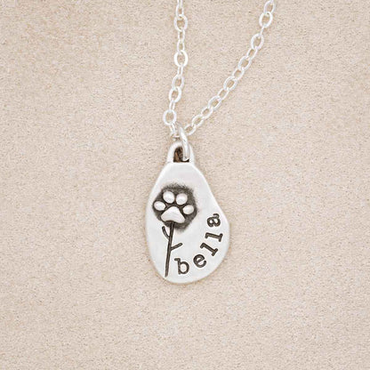 Furry Footprint Flower Necklace, handcrafted in sterling silver, hangs from a link chain