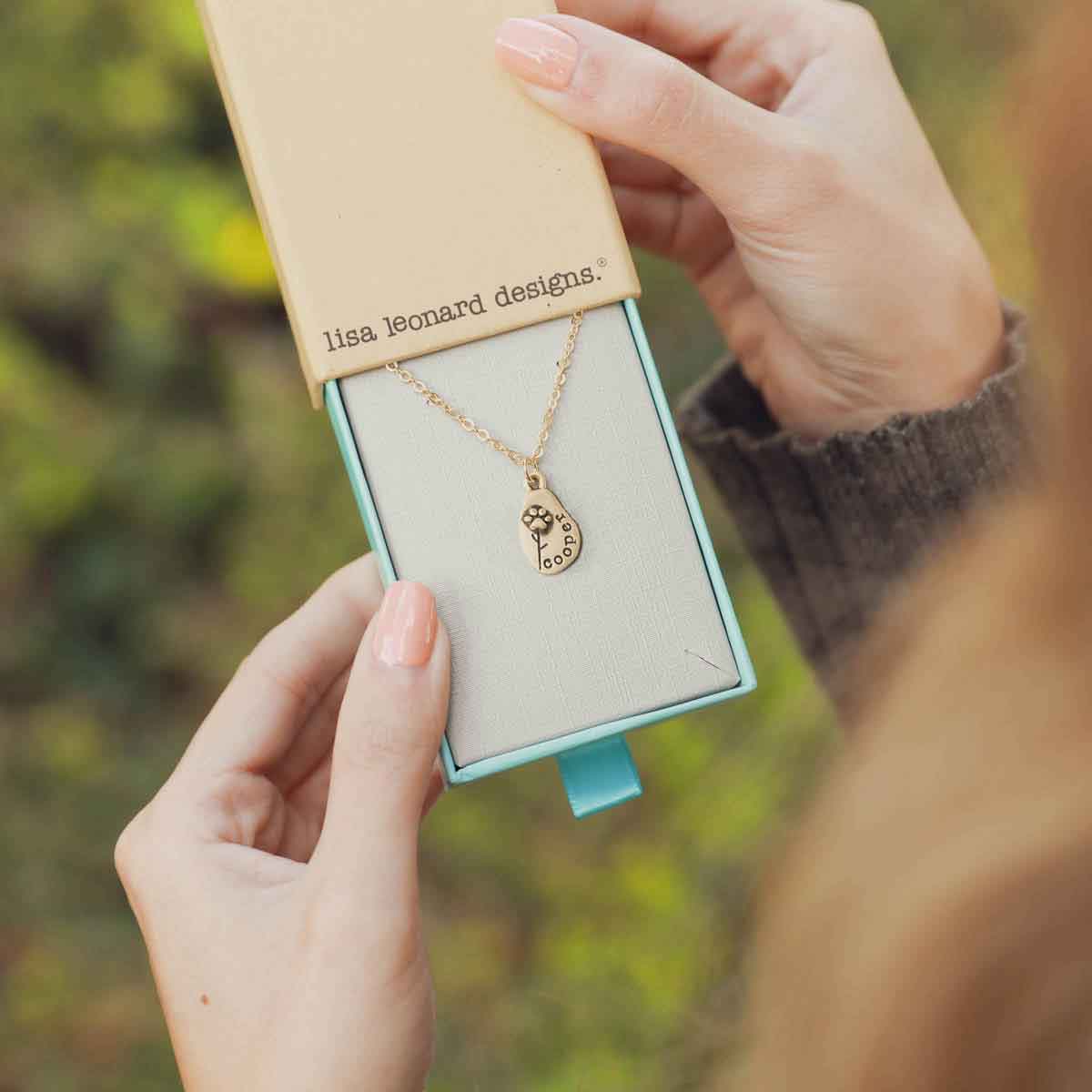 girl wearing a Furry Footprint Flower Necklace