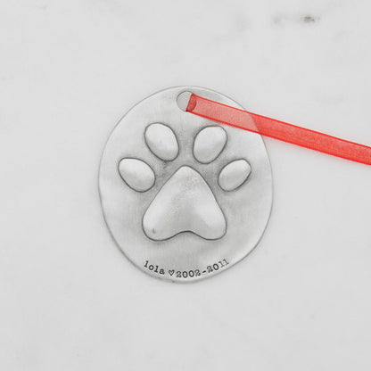 furry footprint ornament hand-molded and cast in fine pewter and personalized with a meaningful name