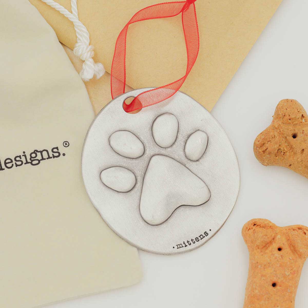 furry footprint ornament hand-molded and cast in fine pewter and personalized with a meaningful name, phrase or date