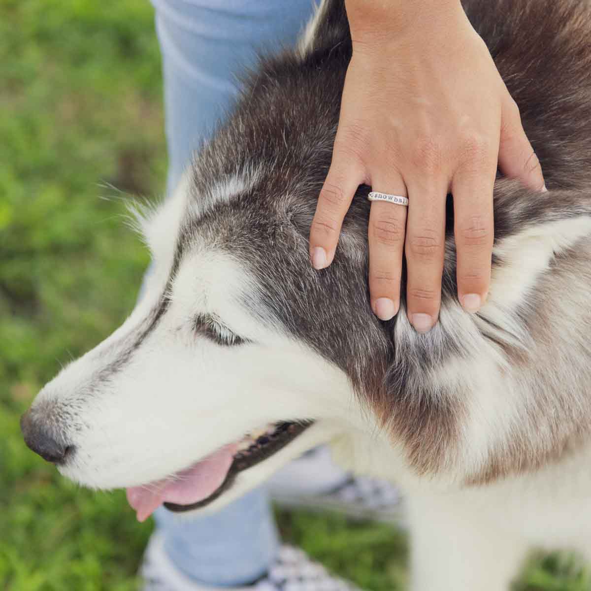 Woman wearing her furry footprint sterling silver stacking ring personalized with her pet