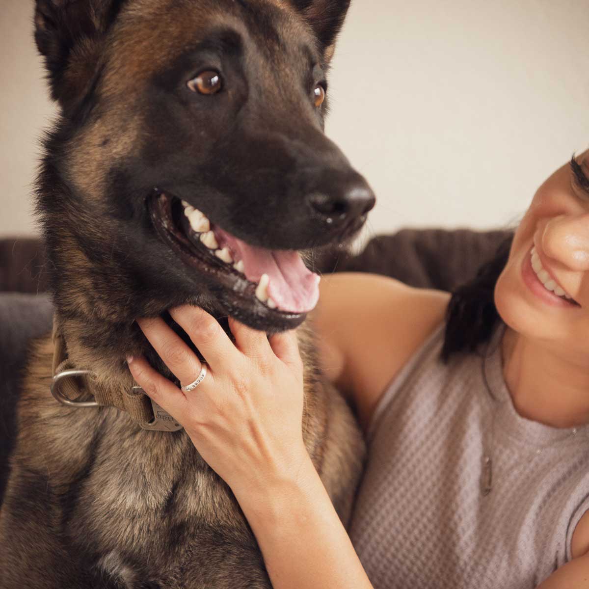 Woman wearing her furry footprint sterling silver stacking ring personalized with her dog