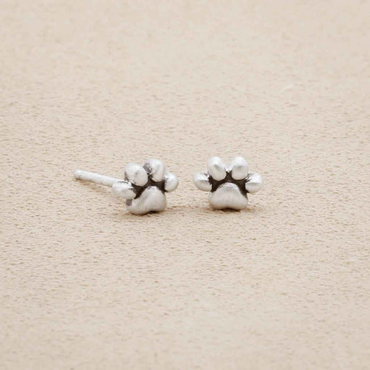 Furry Footprint Stud Earrings handcrafted in sterling silver, on suede