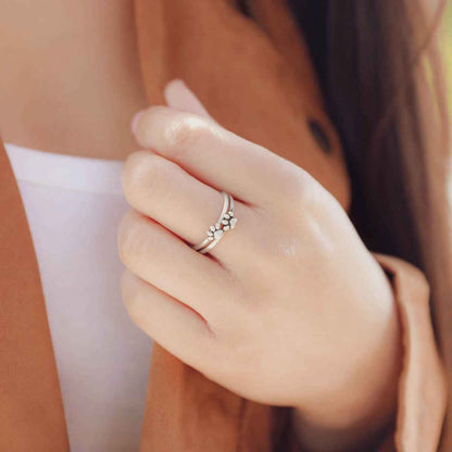 Girl wearing two stacked Furry Footprint Dainty Rings handcrafted in sterling silver